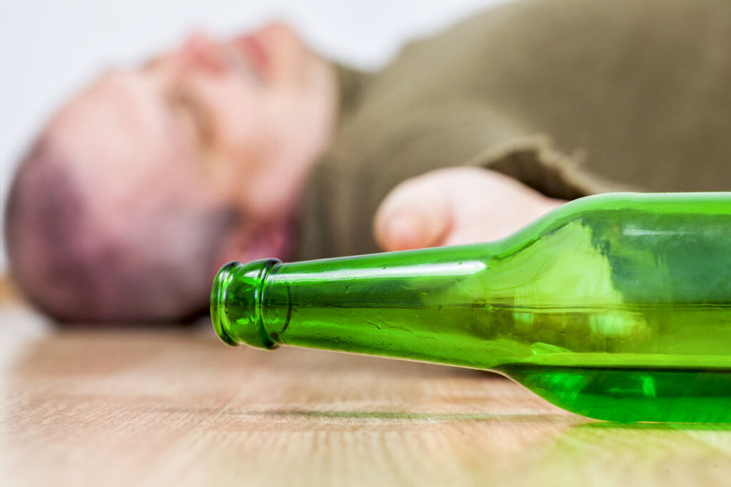 Man lying in floor due to alcohol